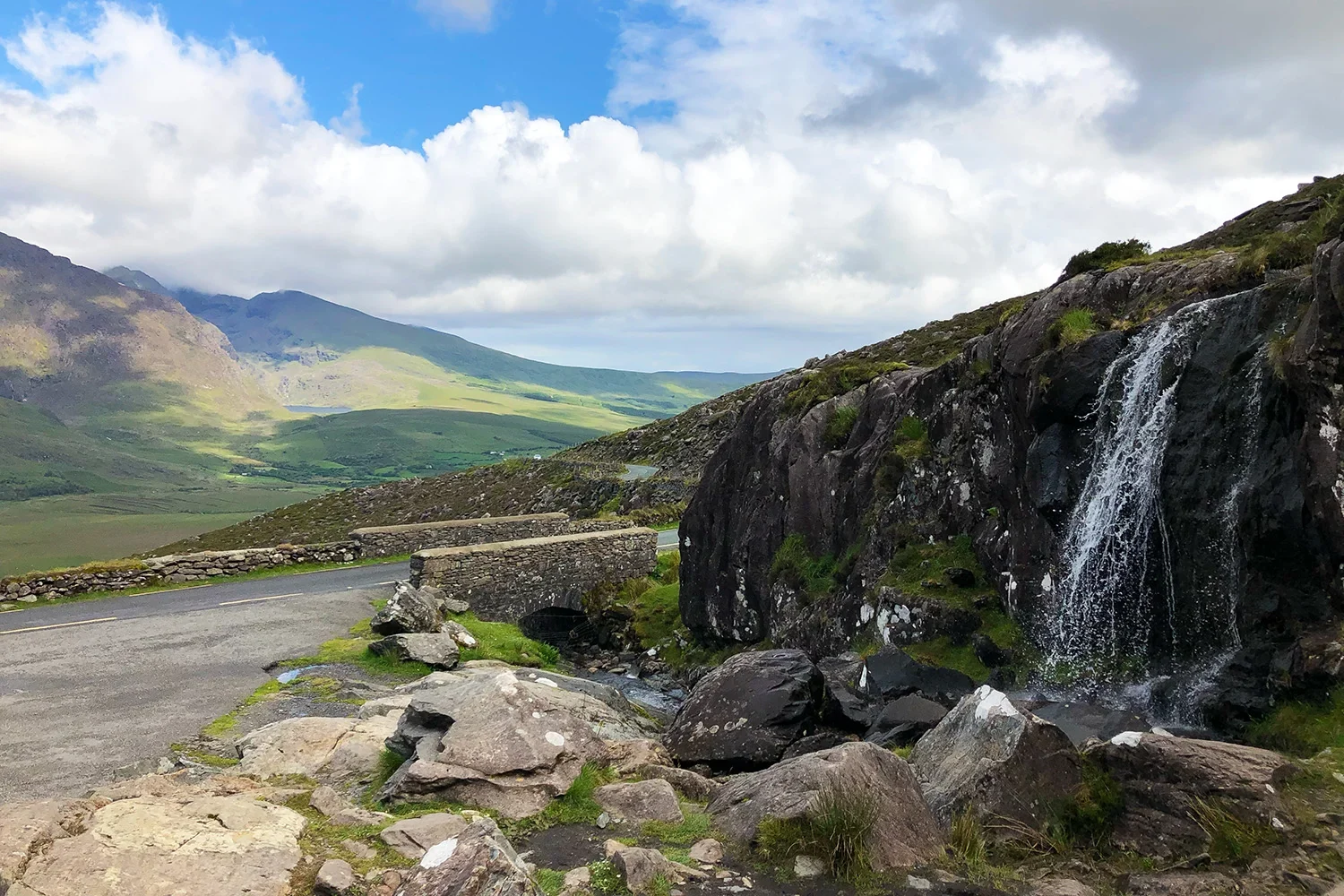 Waterfall and mountain road at Conor Pass near Dingle