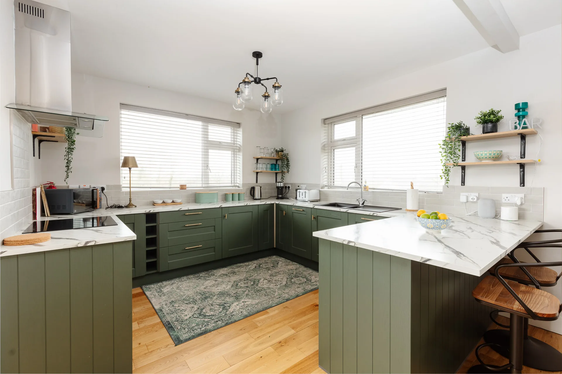 Green kitchen with marble-effect counters